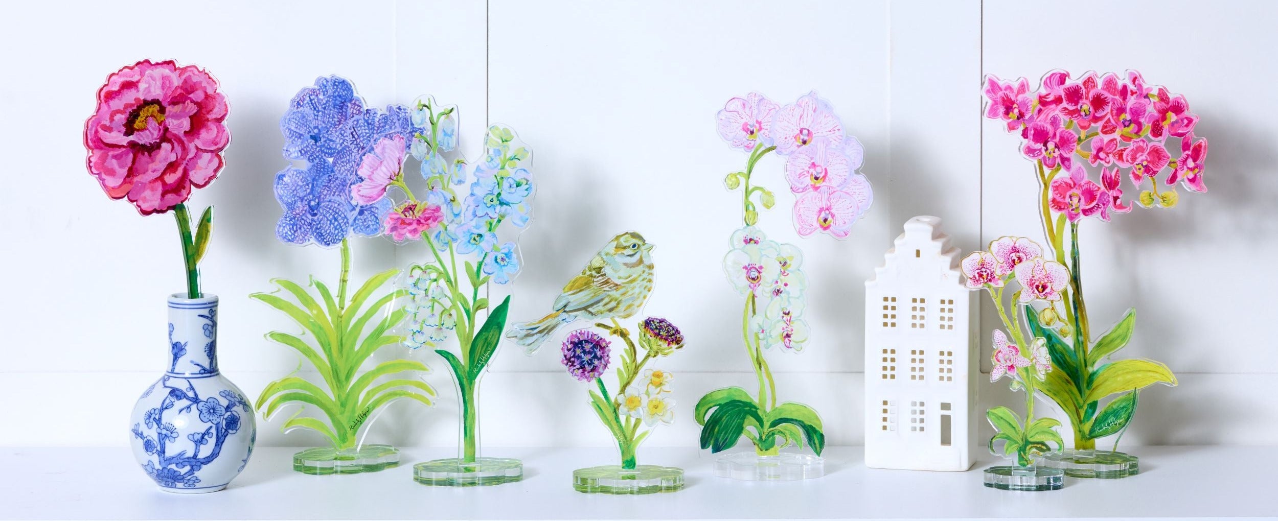 Set of colorful glass plant decorations on a white background